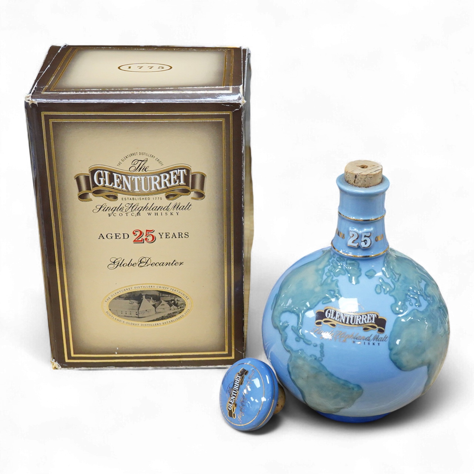 A boxed bottle of Glenturret single highland malt whisky, housed in a globe decanter
